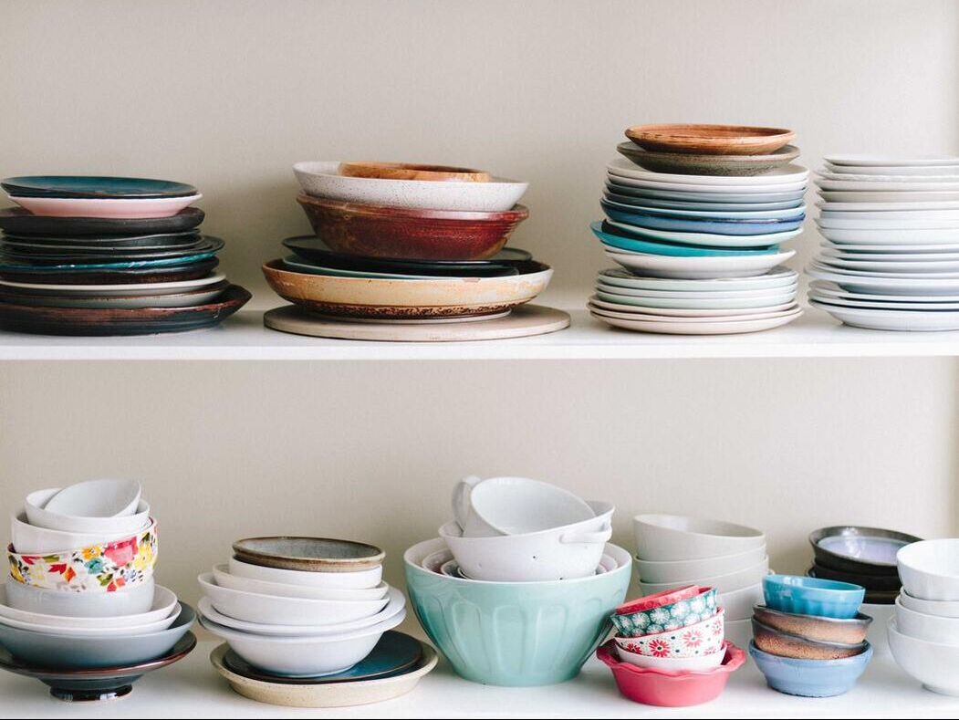 Multiple stacks of random plates and bowls