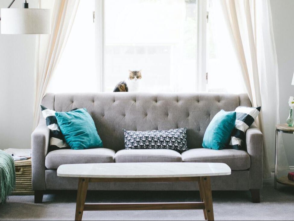 Gray sofa with turquoise and white pillows