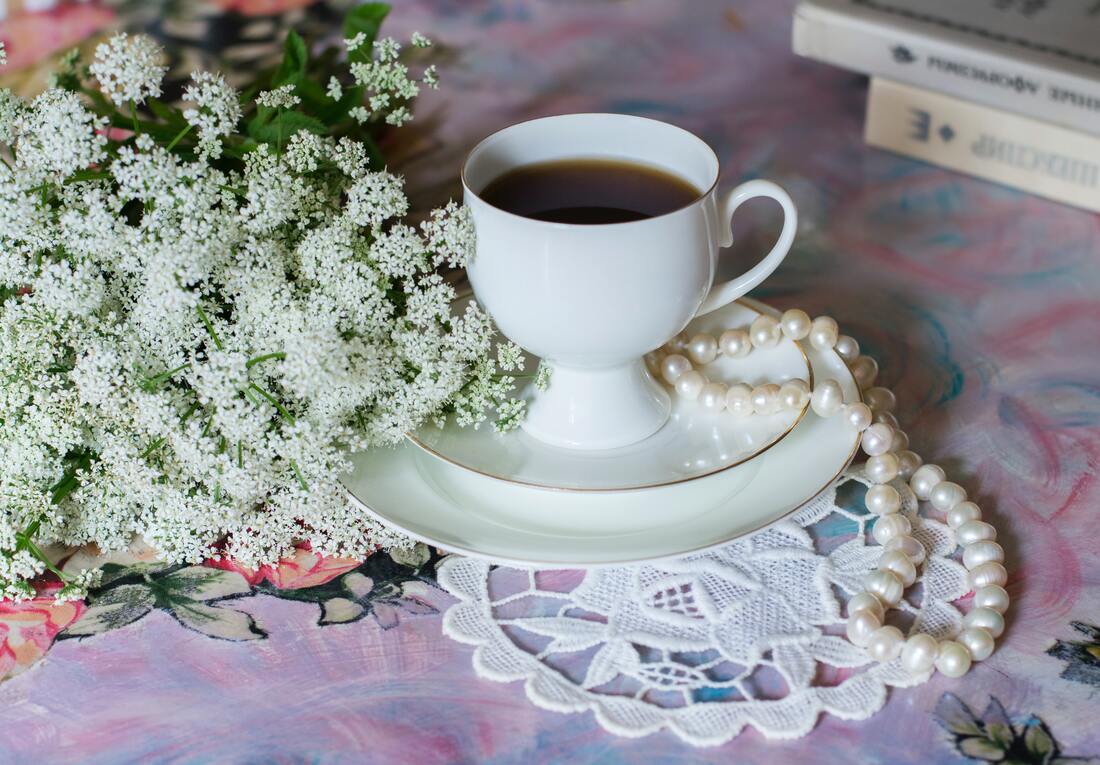 Coffee cup and saucer on a lace doily